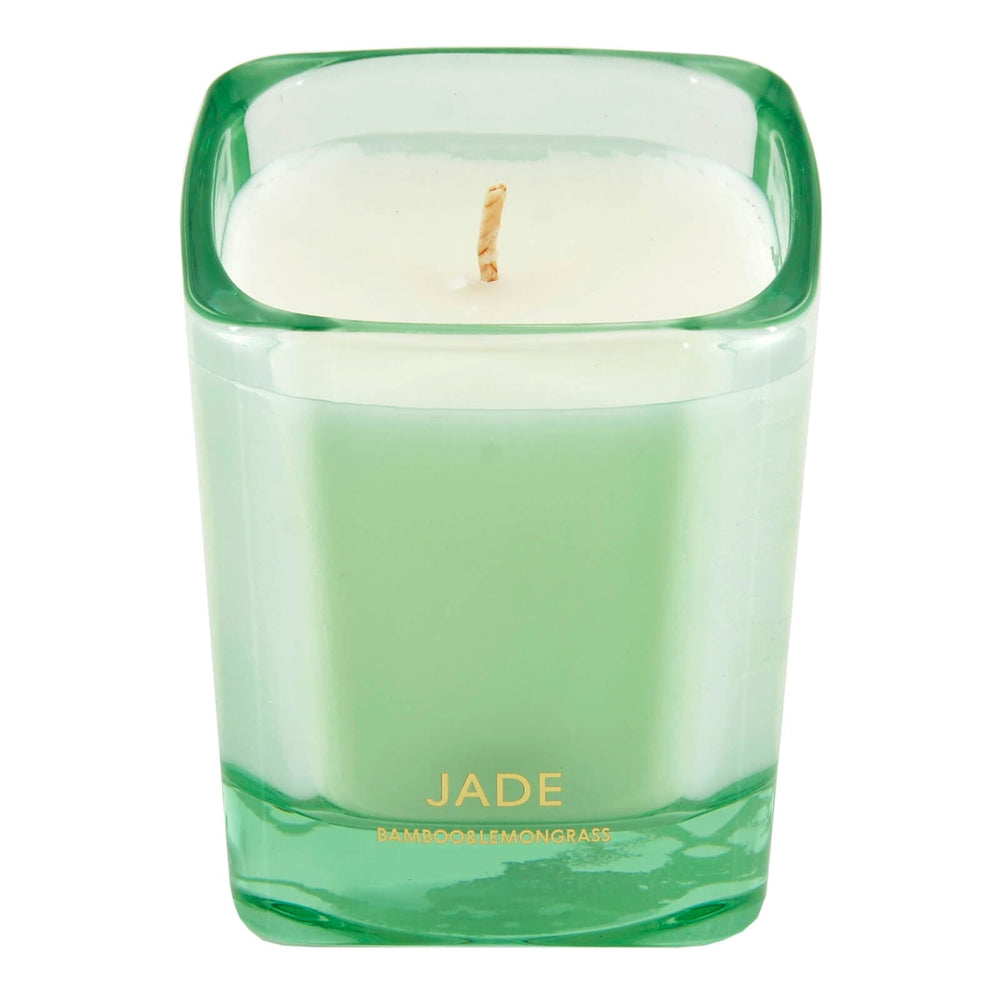 Green candle in a glass container with 'Jade' branding on a white background