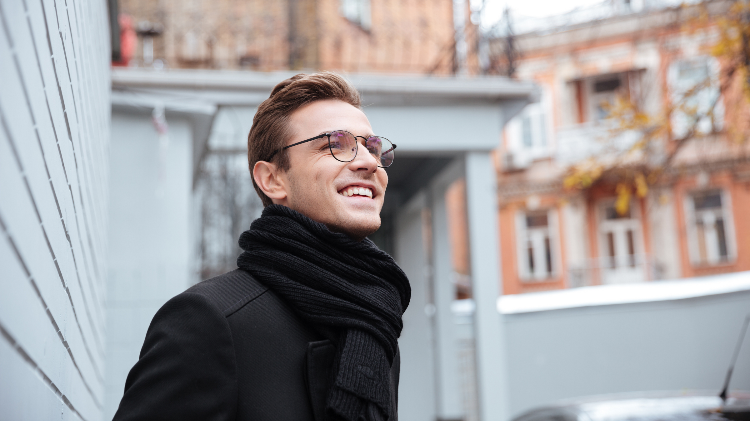 man in outdoor location wearing black winter scarf