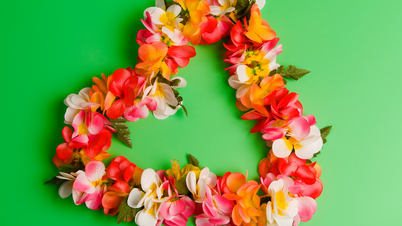 Hawaiian Lei in pink and orange colours on a green background