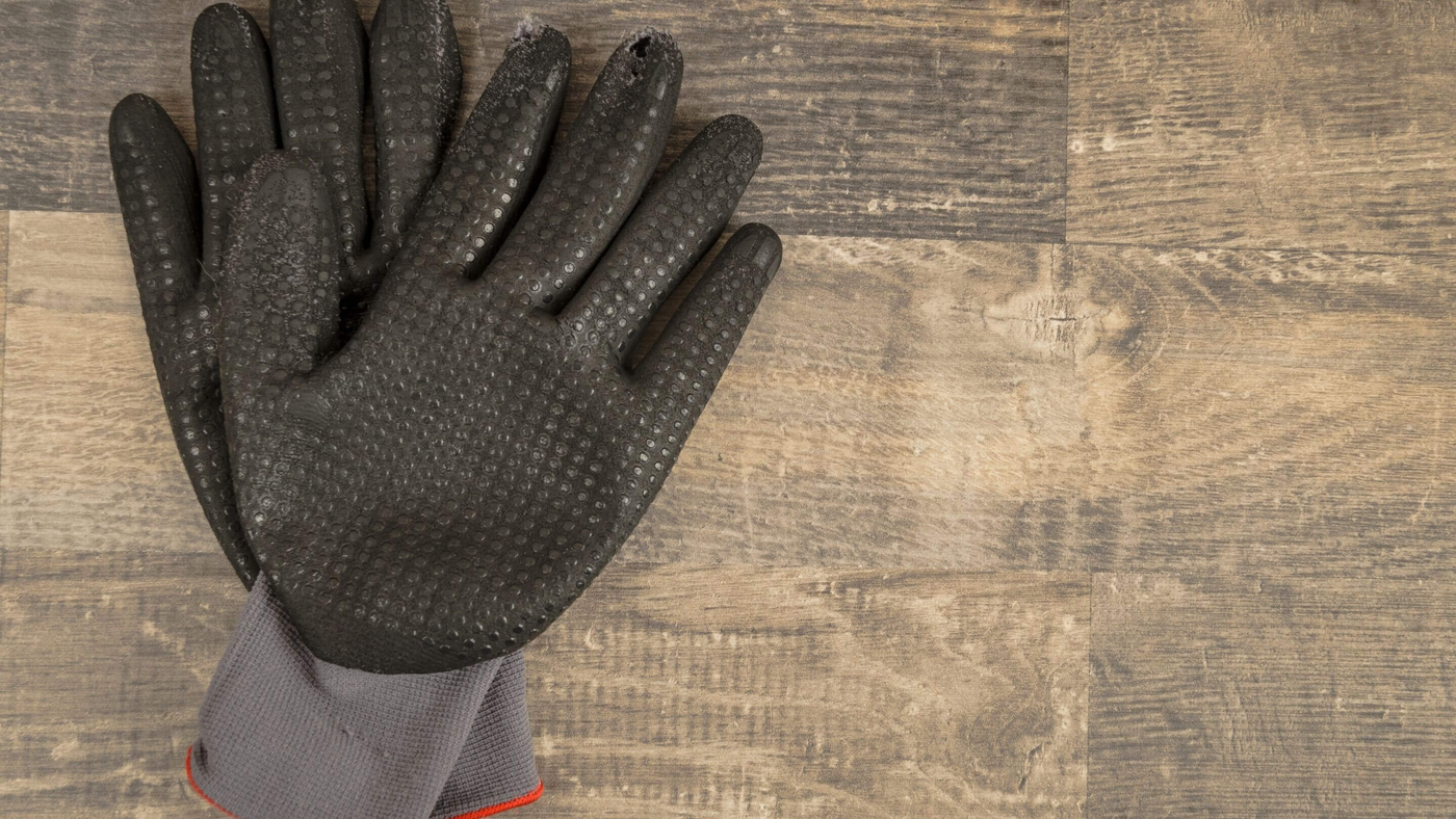 pair of black and grey nitrile gloves on a wooden counter top