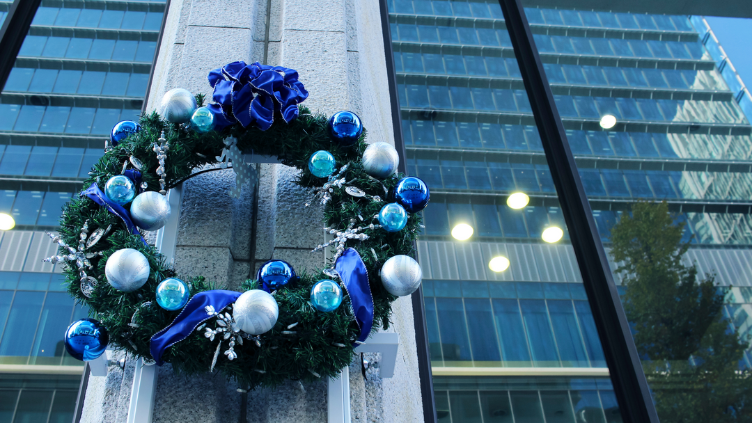 giant wreath decorated with blue baubles on a business building window