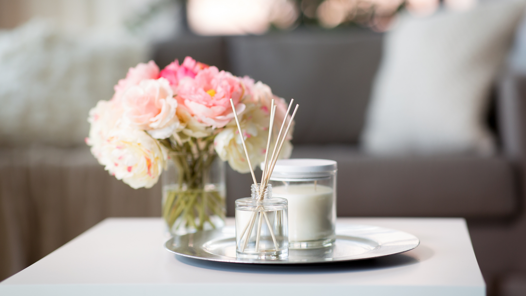 green tea light candles spaced on white worktop with flame