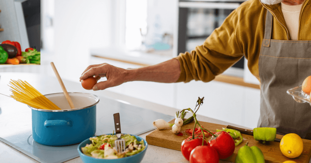 A person making Spaghetti on a hob 