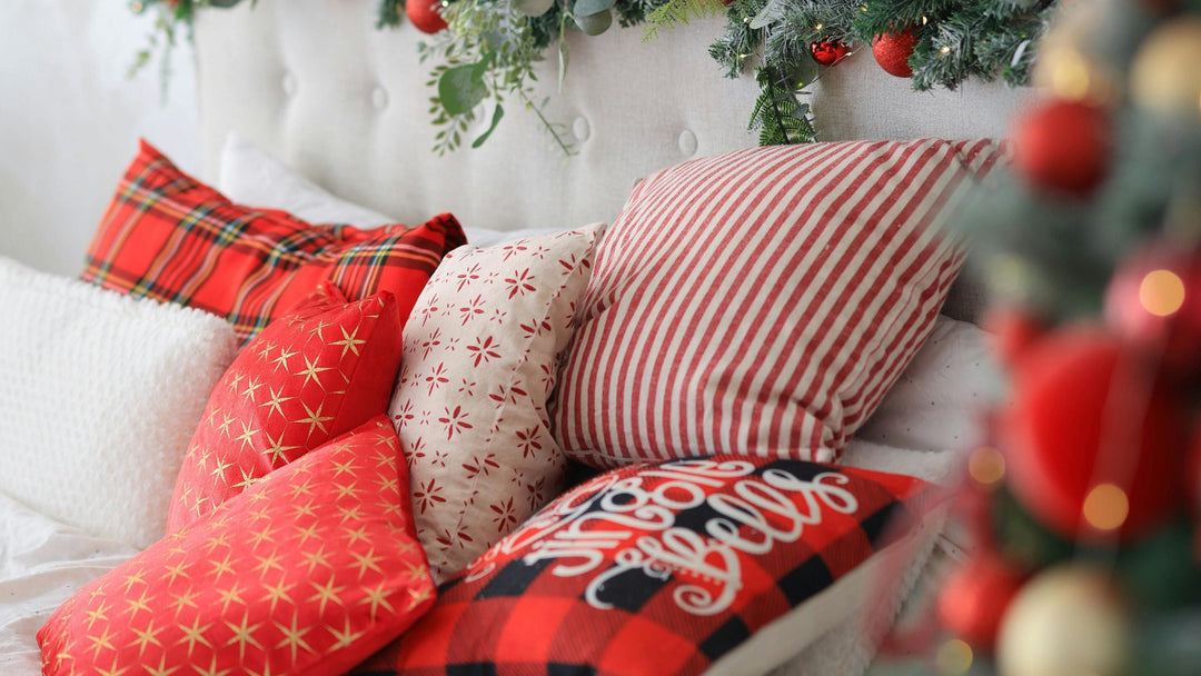 red and white cushions and blankets on white sofa