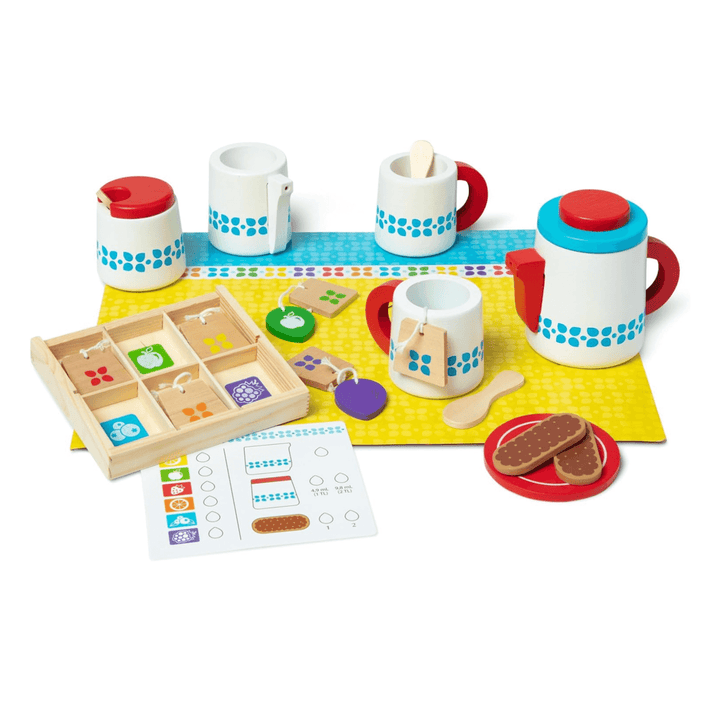 full tea set for 2 laid out on white background including wooden mugs, biscuits, tea bags and serving tray