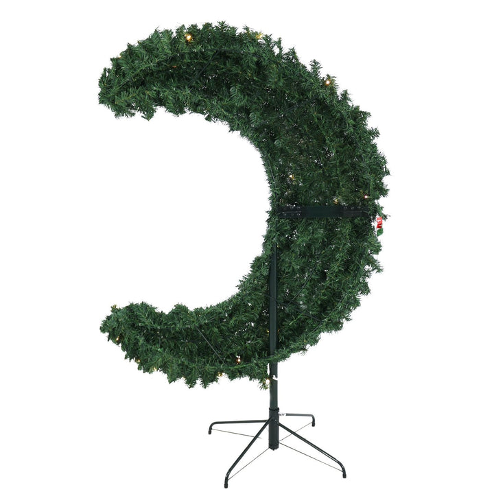 Curved artificial Christmas tree on a stand with lights against a white background
