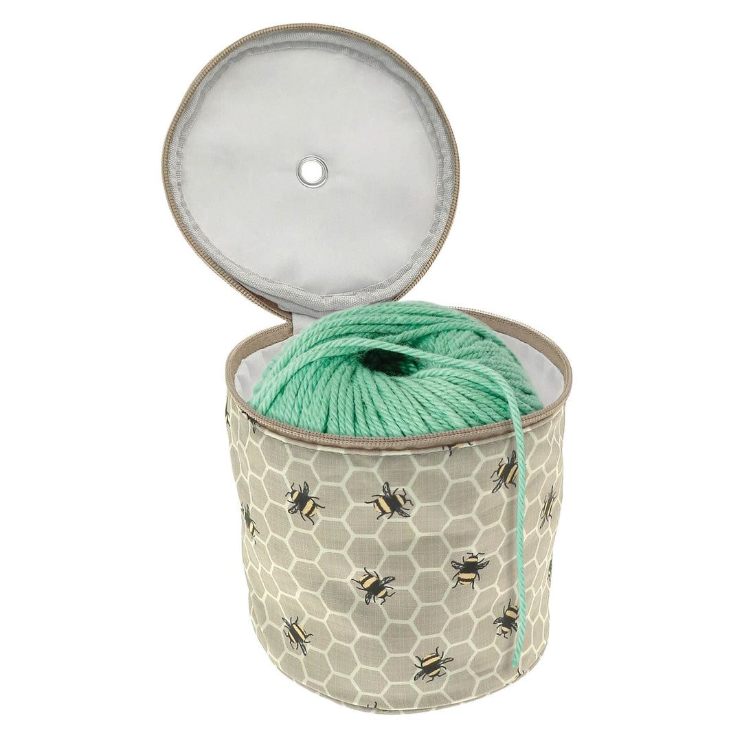 Bumblebee and honeycomb pattern knitting wool holder bag open to show a ball of wool inside