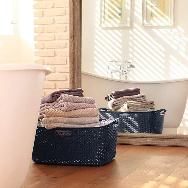 Bathroom with dark grey laundry basket full of towels