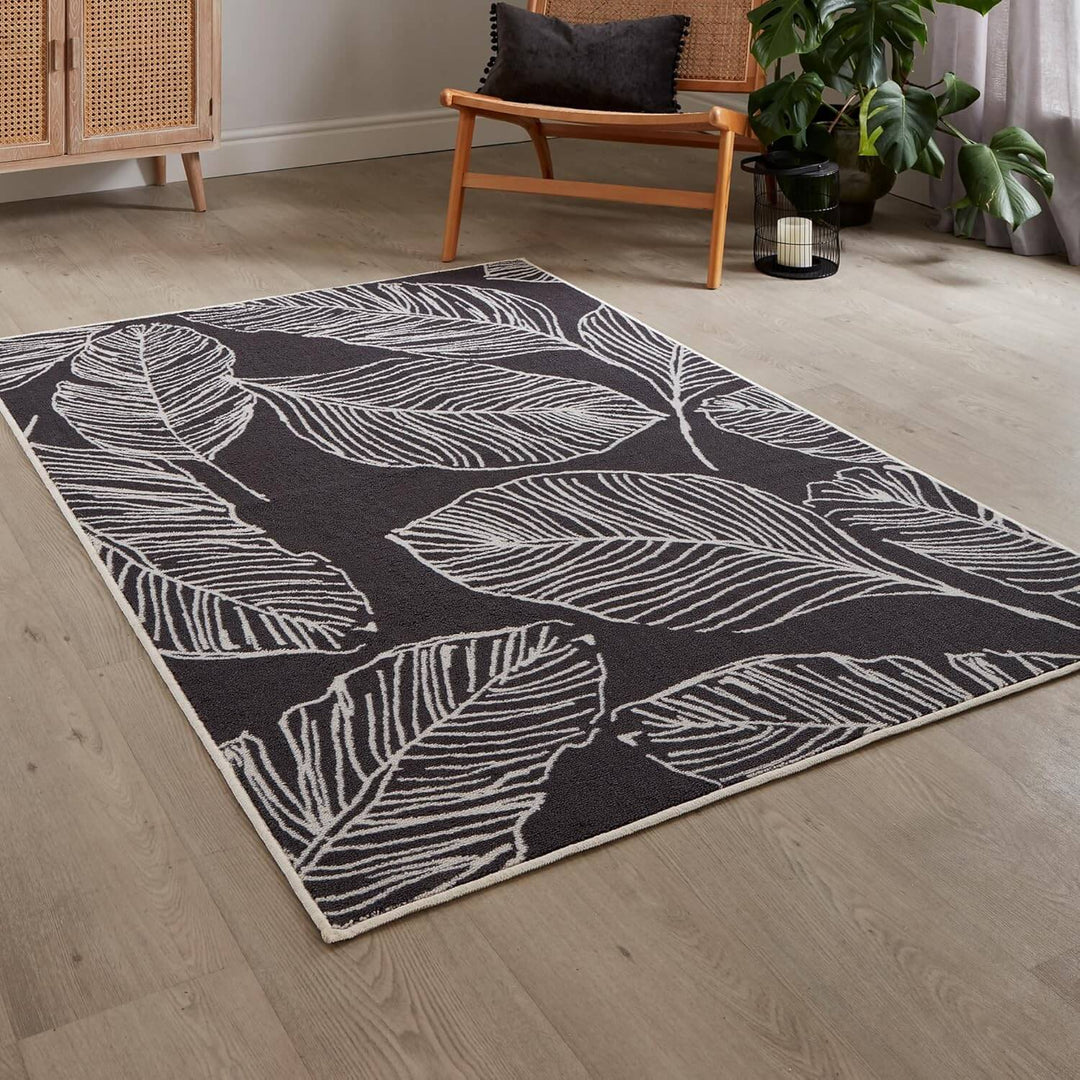 Dark grey indoor rug with large leaf pattern