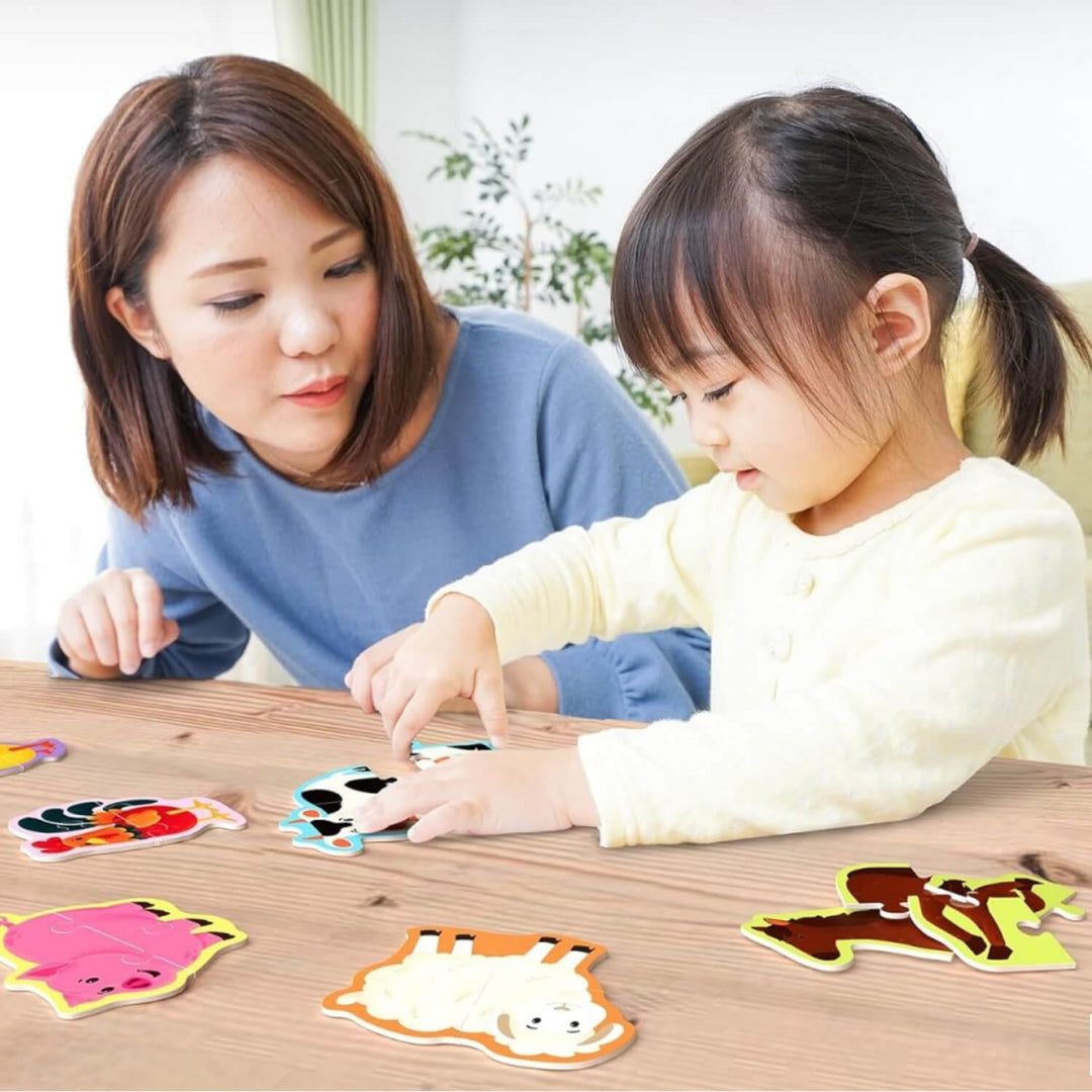 Mother and child completing a cow farm animal jigsaw puzzle