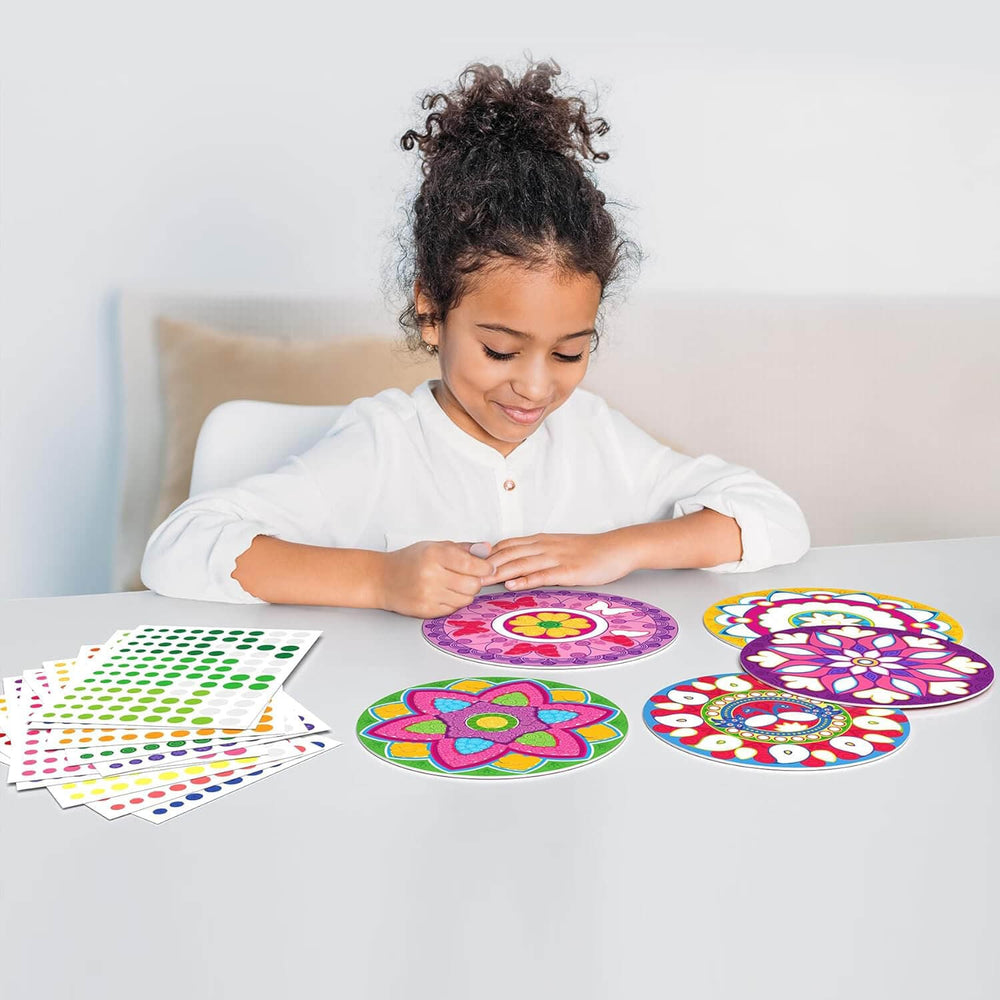 girl creating a colourful mandela with stickers