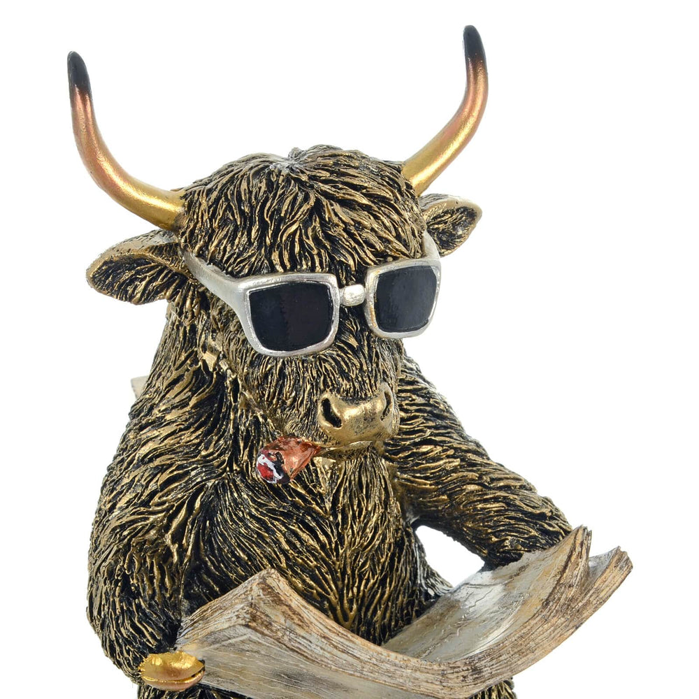 Close up of a highland cow sculpture with sunglasses and cigar