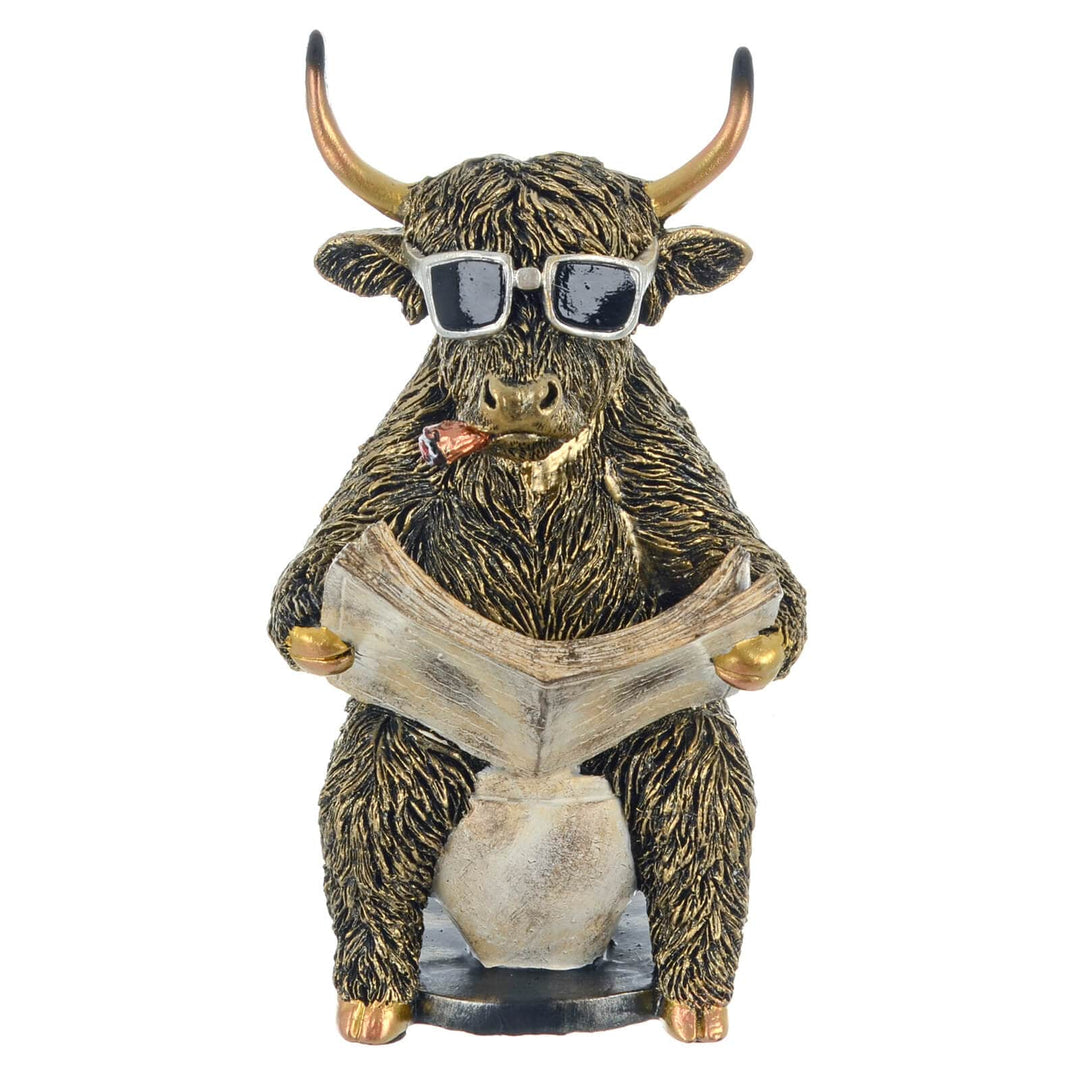 Funny Highland cow sitting on a toilet