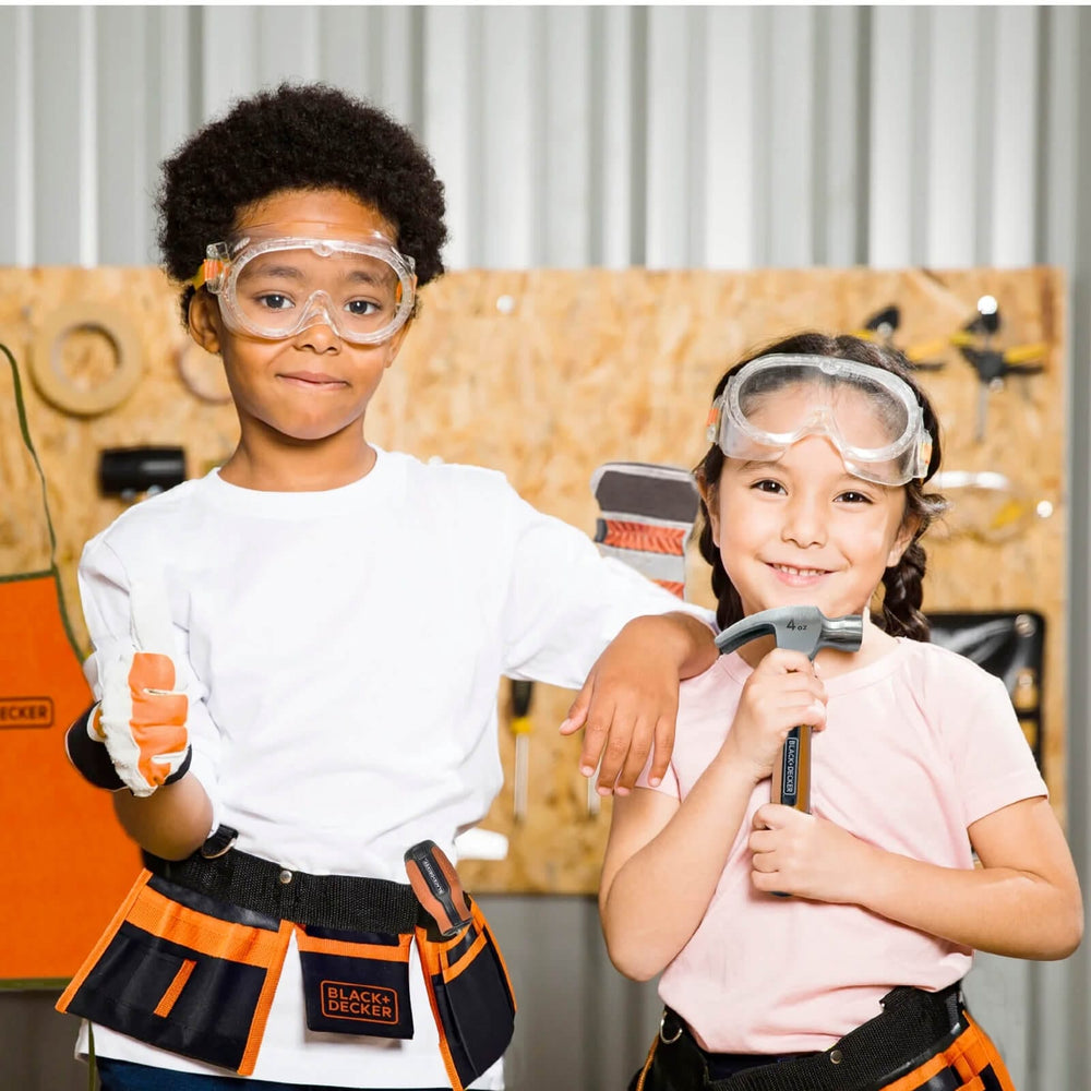 Boy and girl with Black + Decker tools and safety goggles