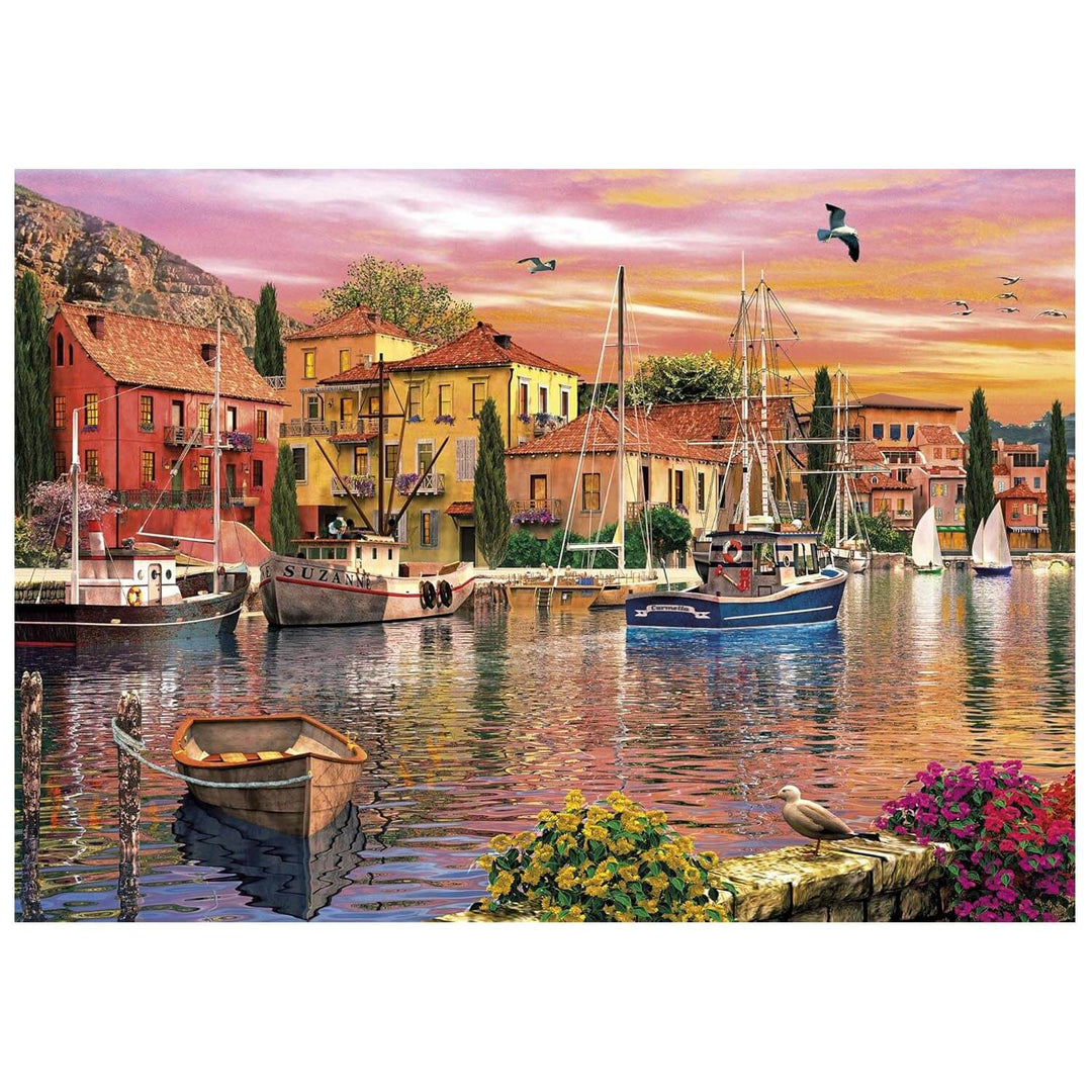 Sunset over a river with buildings boats and seagulls