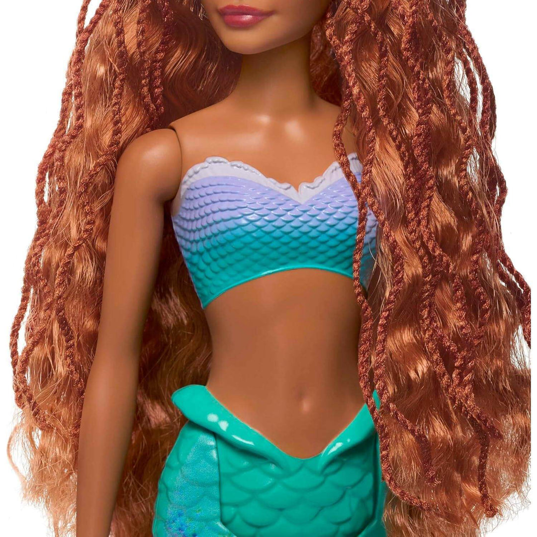 Close up of red hair and fishscale top on a mermaid doll