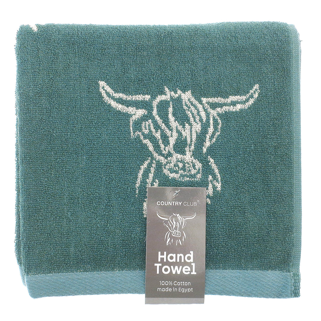 Teal hand towel with cow design and 'Country Club' label on a white background