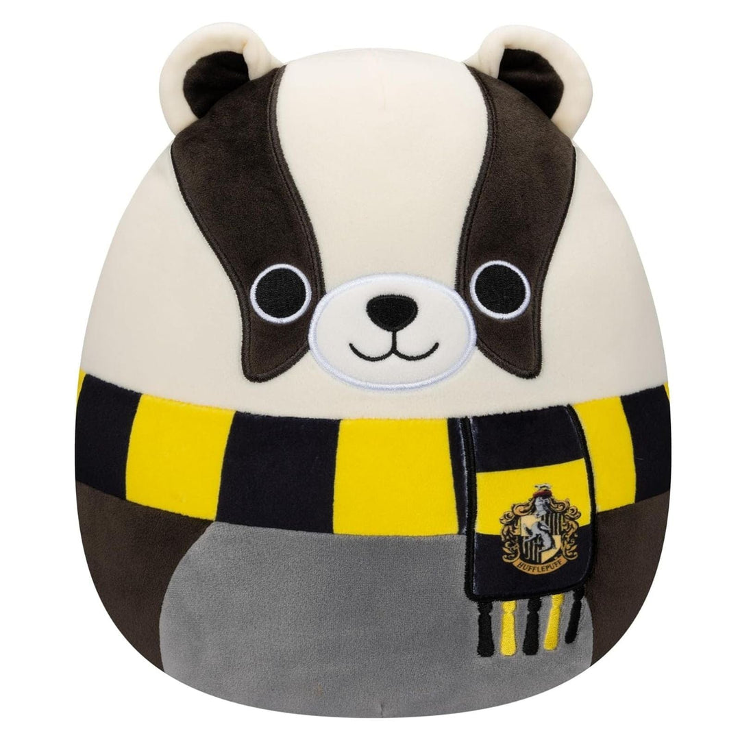 Plush toy resembling a badger with a Hufflepuff scarf on a white background