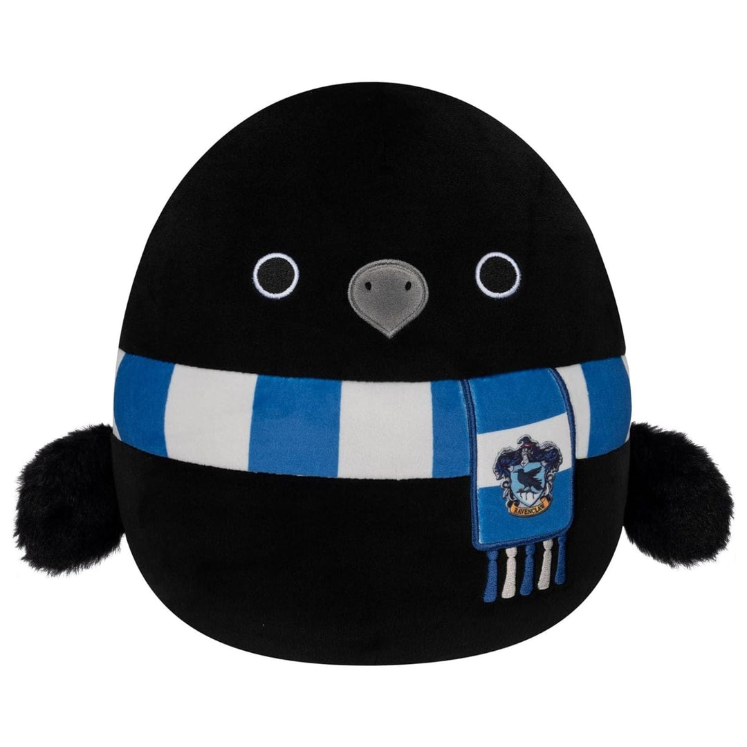 Plush toy raven with a blue and white scarf and ravenclaw crest on a white background