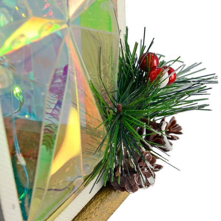 Close up of pne cone and red berries on the bae of a Christmas lamp post decoration