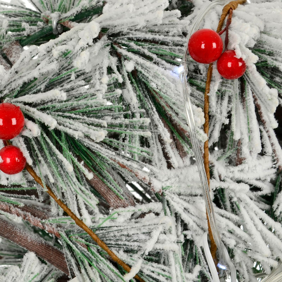 Detail of LED light and red berries on a Christmas wreath