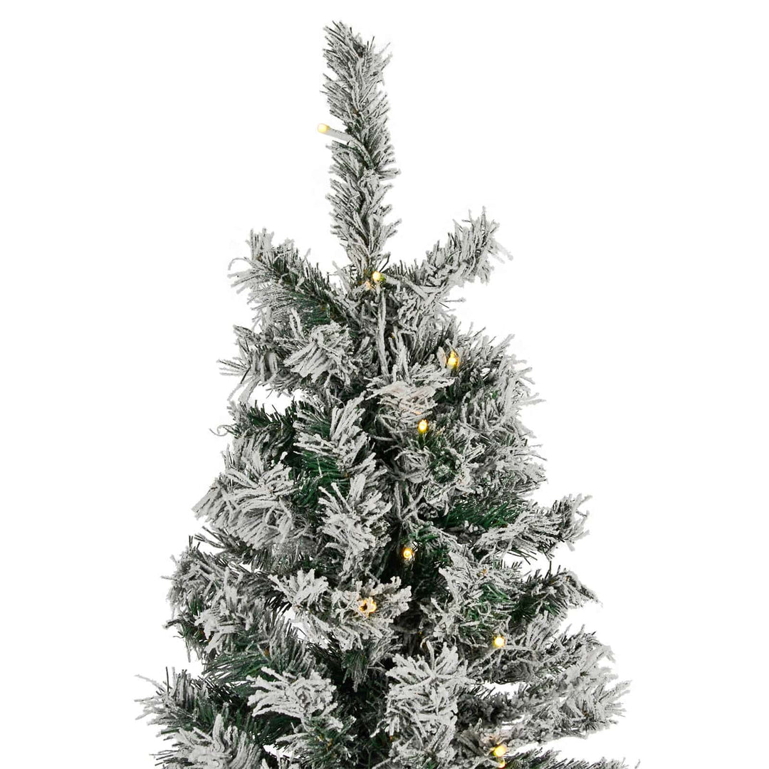 Top of a pre-lit Christmas tree with frosted branches