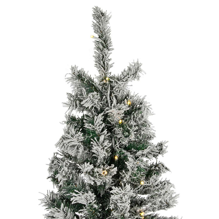 Top of a pre-lit Christmas tree with frosted branches