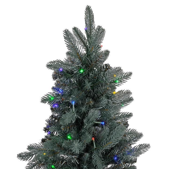 Top of a pre-lit Christmas tree with mylti coloured lights