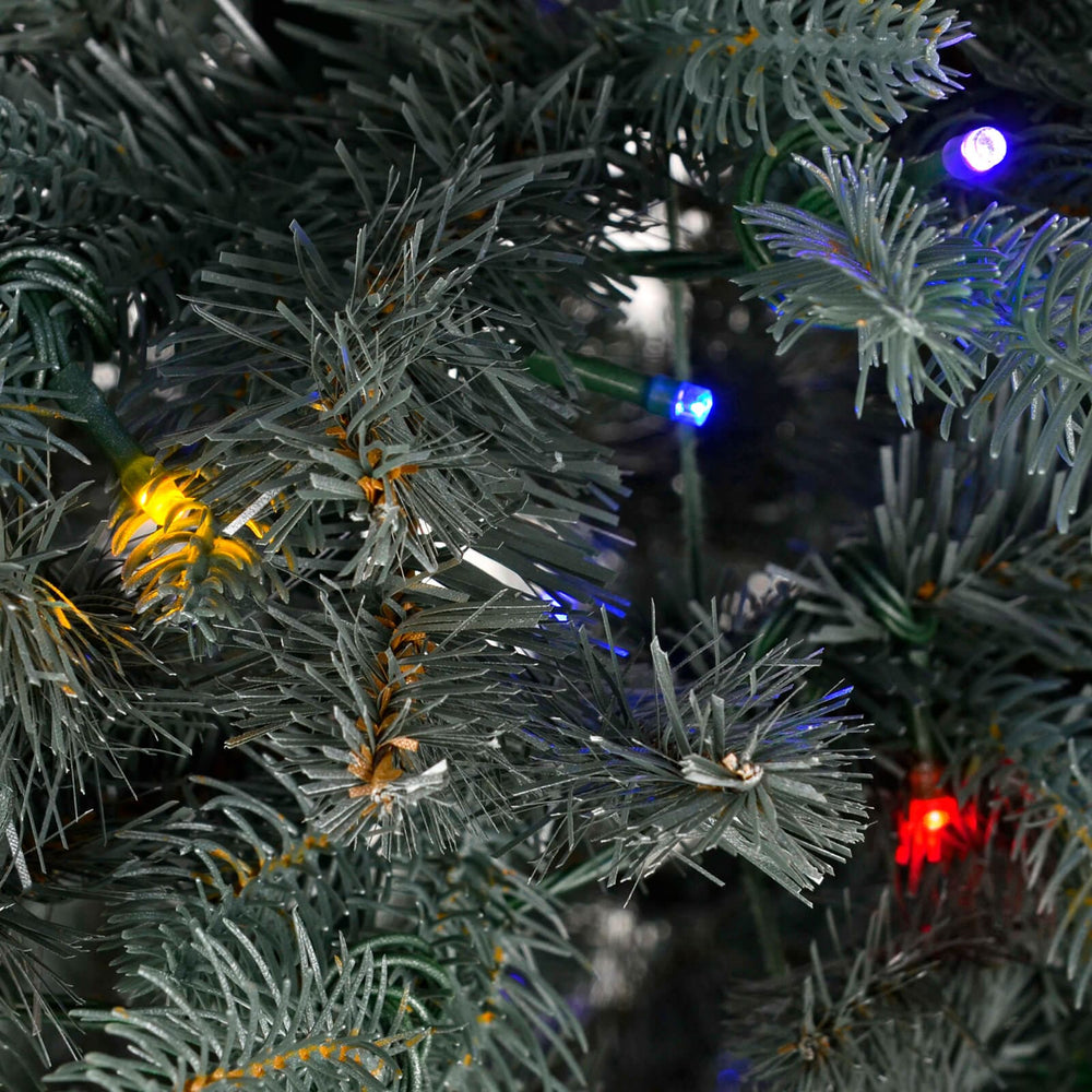 Close up of multicolour LED fairy lights on an artificial Christmas tree
