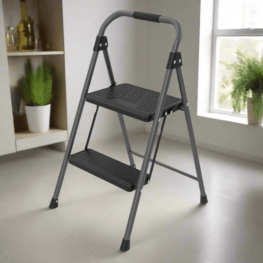 Two-step metal step ladder in a room with a window and plants.