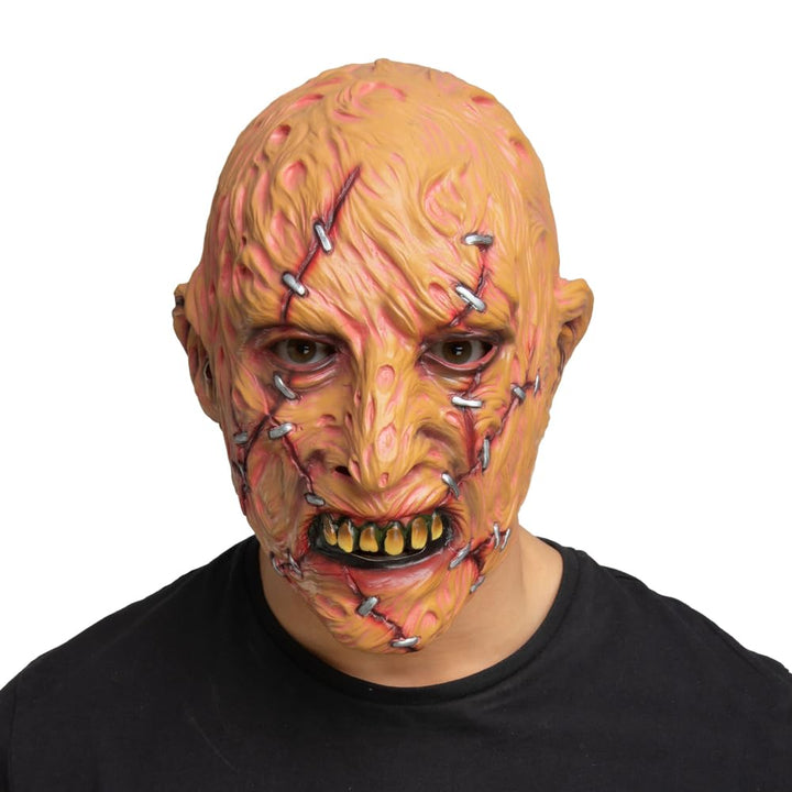 Person wearing a horror-themed mask with stapled skin and a black shirt on a white background