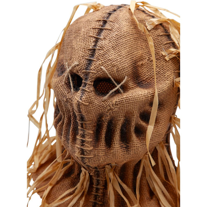 Scarecrow head made of burlap with straw on a white background