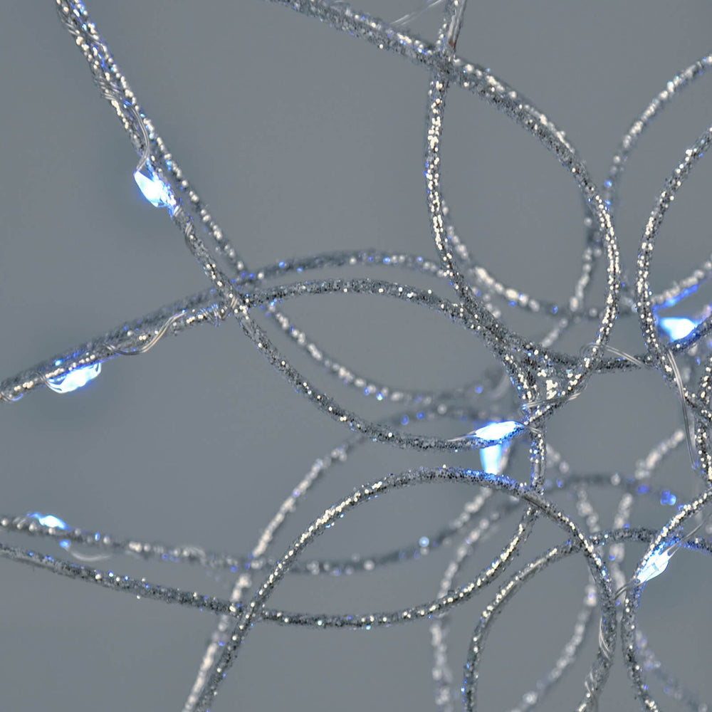 Close up of a silver glitter frame tree topper with ice white LED lights