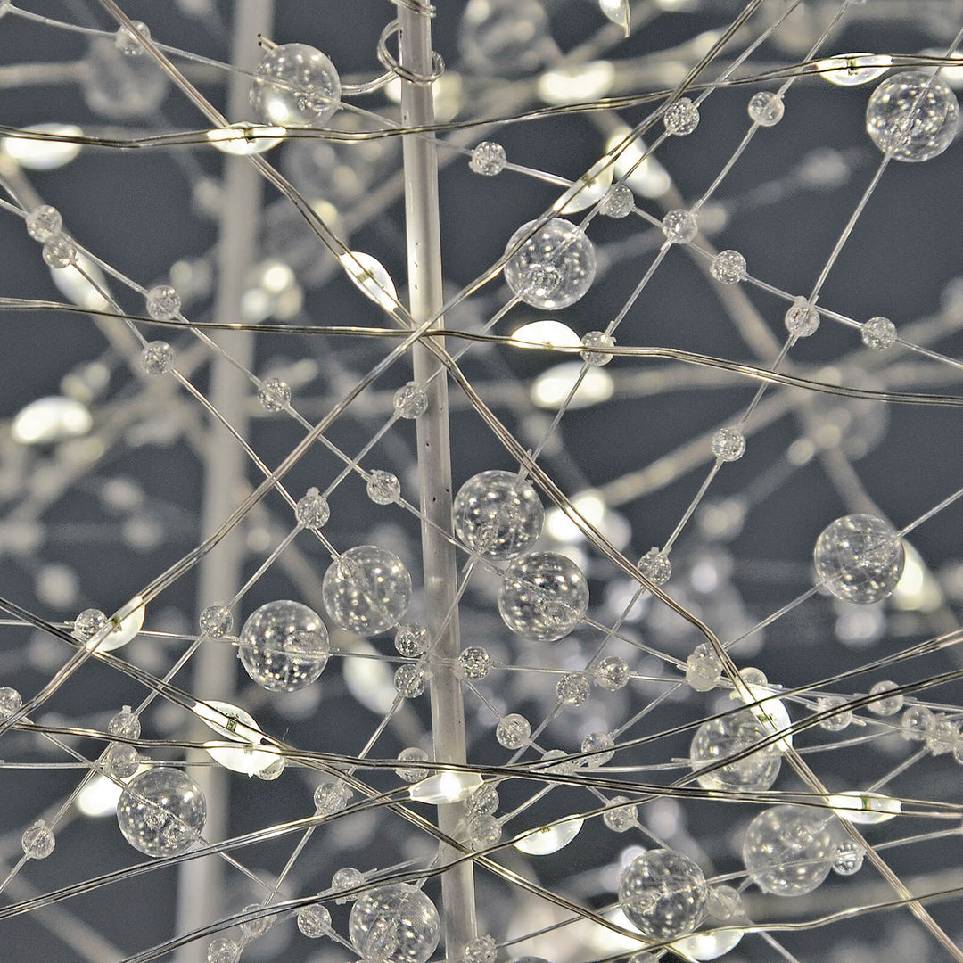 Close up of beads and LED lights on a white wire frame Christmas tree