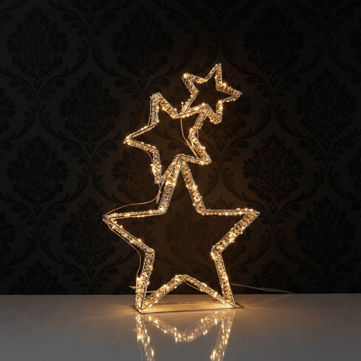 Decorative star-shaped light fixture on a reflective surface with a dark patterned background