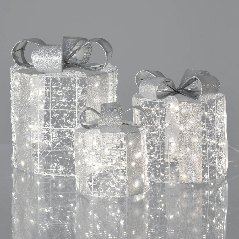 Set of 3 pre-lit Christmas gift boxes decoration on grey background