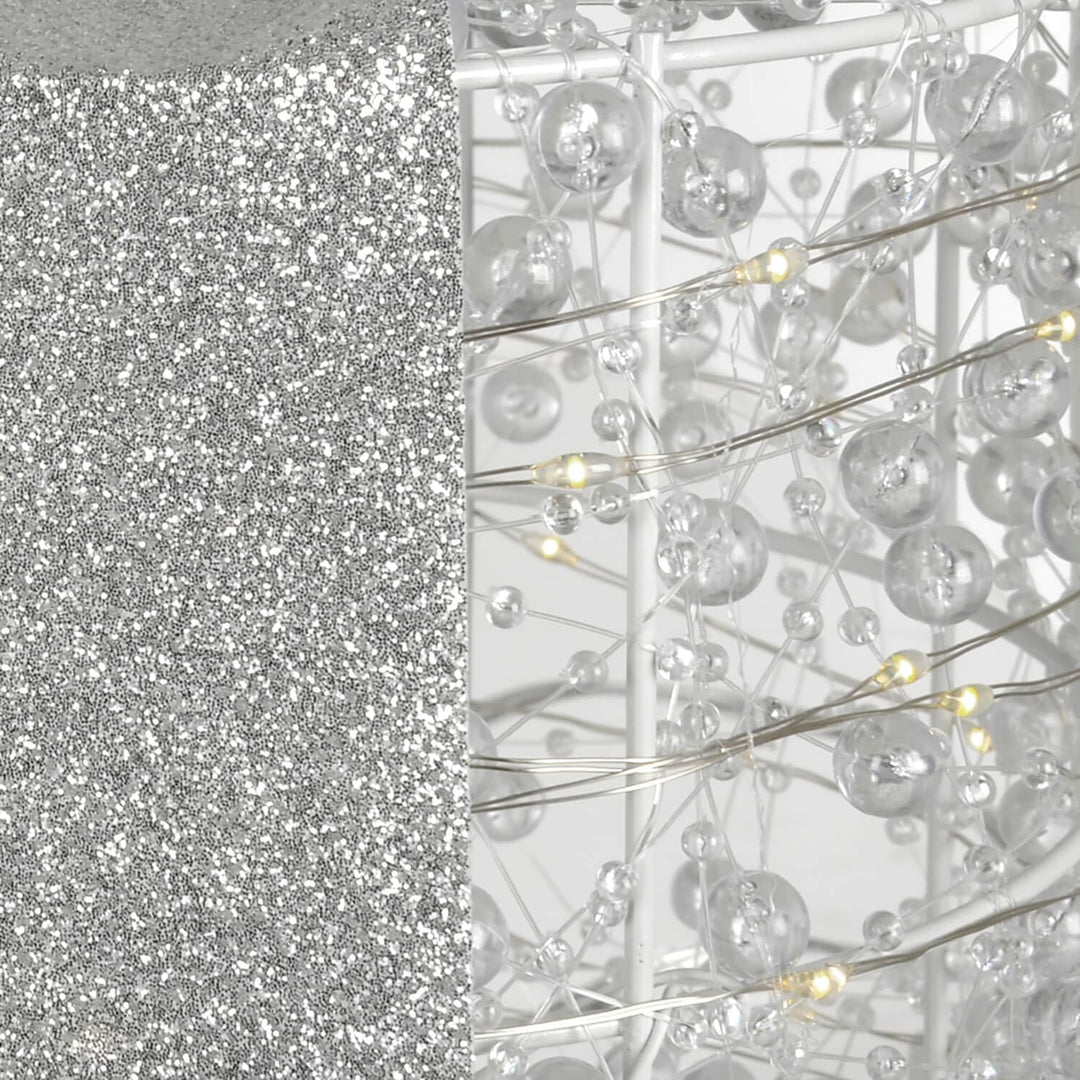 Close up of glitter ribbon and white LED lights on a Christmas decoration