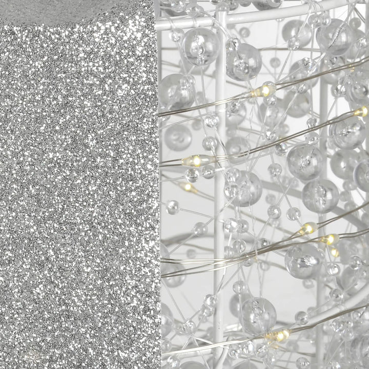 Close up of glitter ribbon and white LED lights on a Christmas decoration