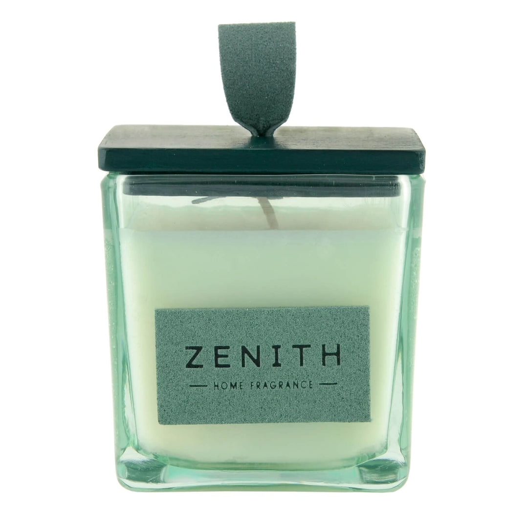 Candle in a glass container with a green lid and 'Zenith' label on a white background