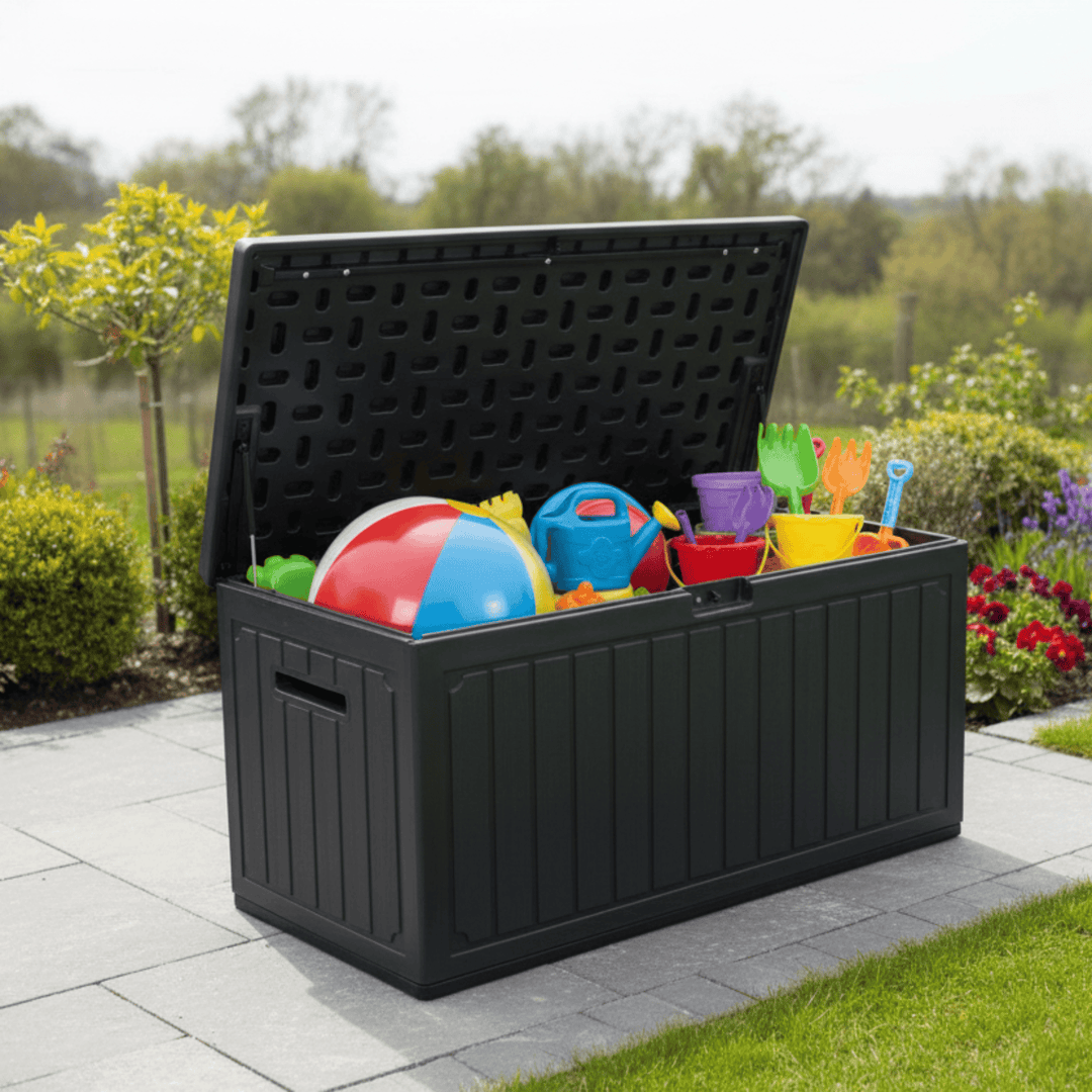Black storage box with colorful toys on a patio with a garden background