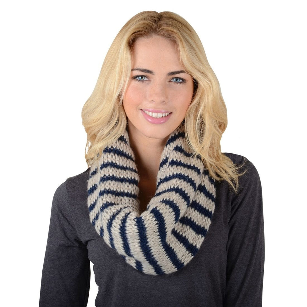 model wears beige and navy stripe knitted snood on a white background with dark grey long sleeved top