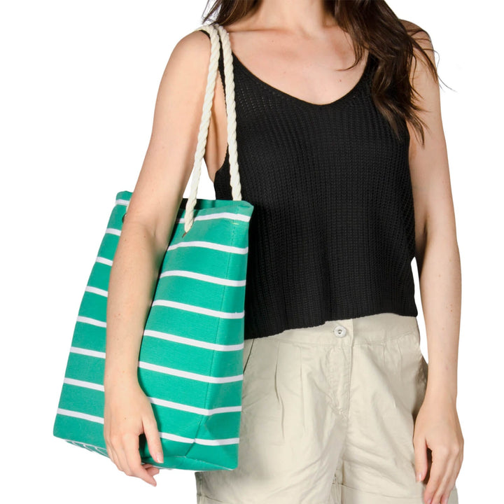 Person carrying a green striped shoulder bag on a white background