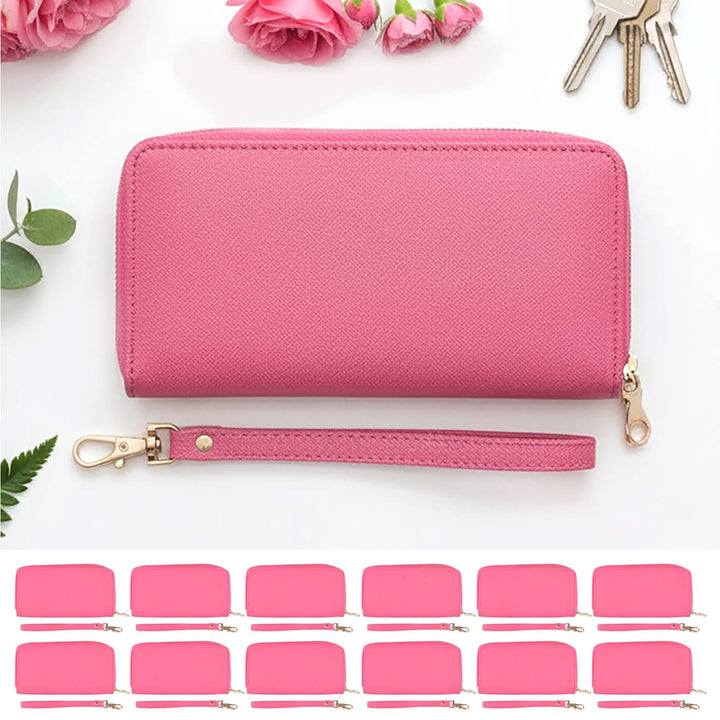 Pink leather purse with a strap on a white background with pink flowers and keys.