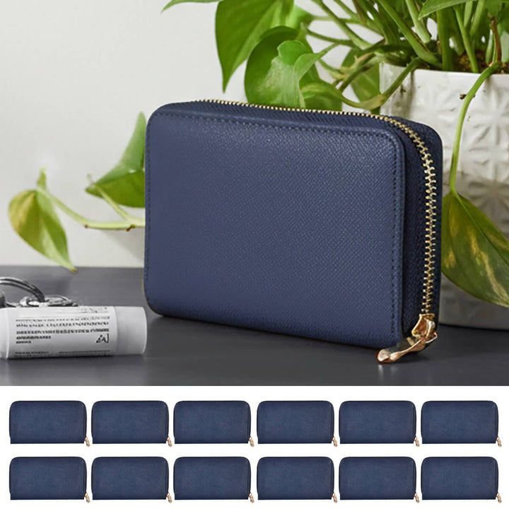 Blue purse with gold zip on a dark grey table with plants in the background