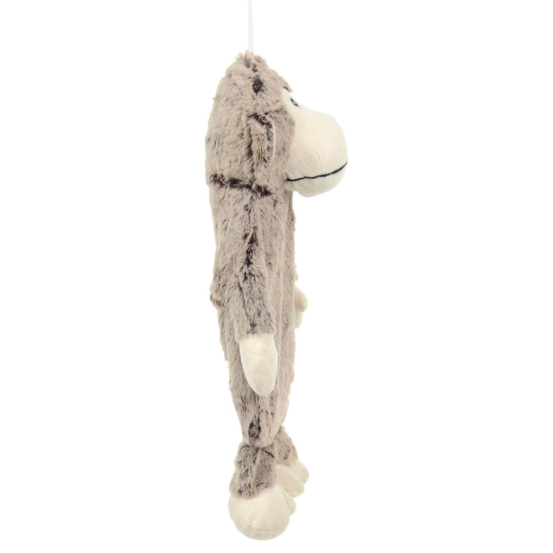 Side view of a padded plush monkey hot water bottle cover on a white background