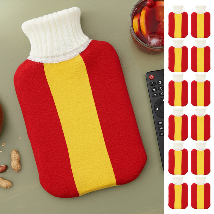 Red and yellow Spanish flag hot water bottle on a sage green wooden surface with a glass pf Sangria, peanuts and a remote control