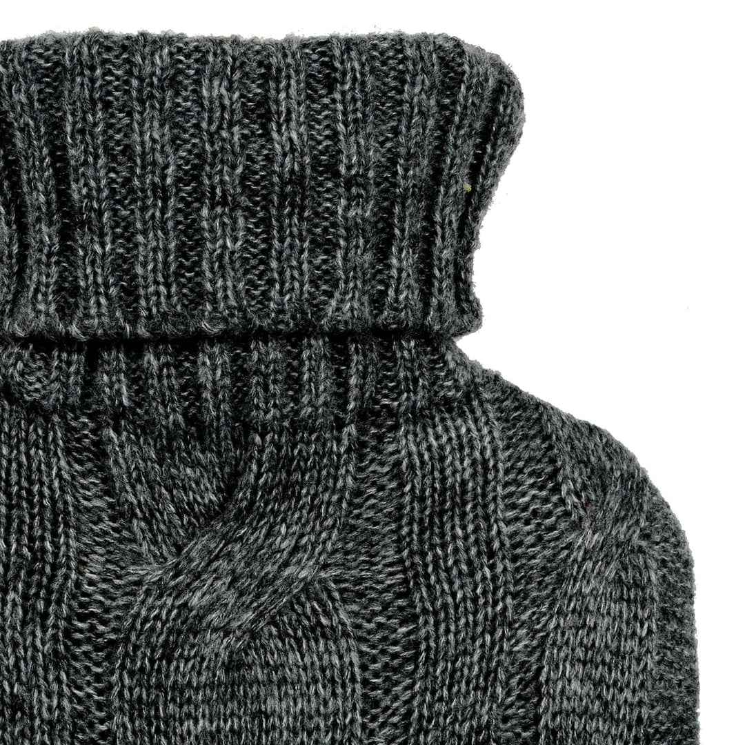 Close up of a dark grey cable design knitted cover on a hot water bottle