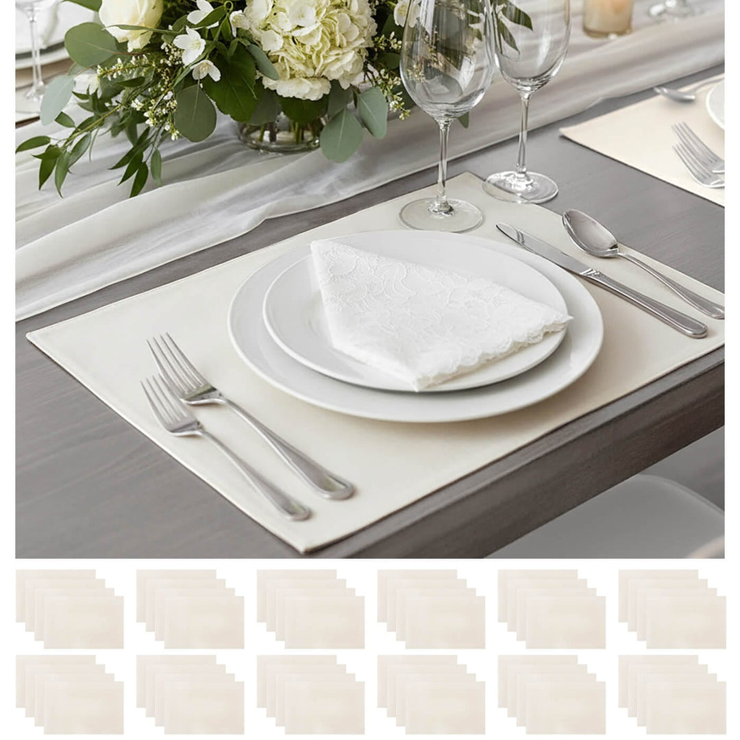 Elegant table setting with white plates, silverware, and a floral centerpiece.