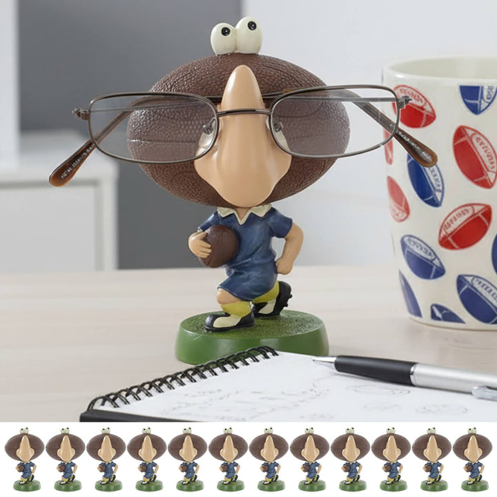 Rugby player figure glasses older on a desk with cup