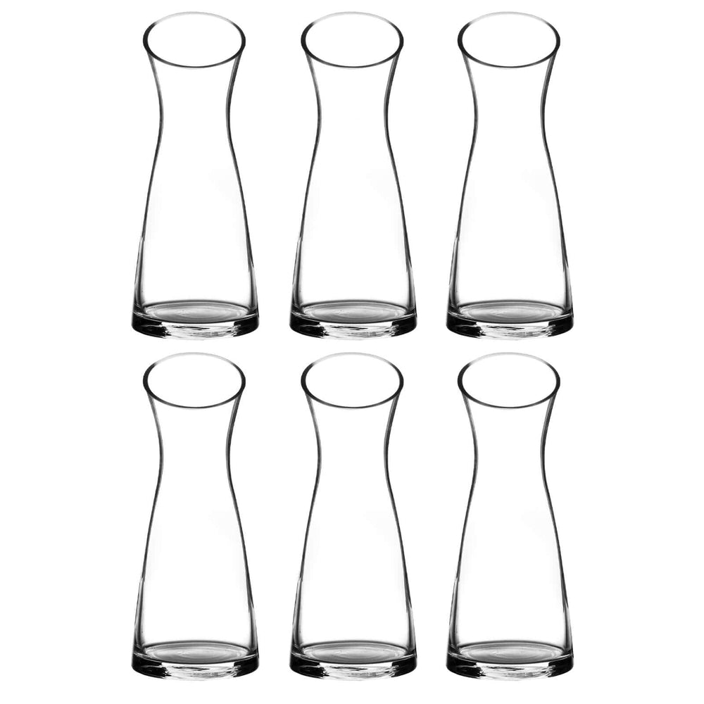Set of six clear glass large flower vases on a white background